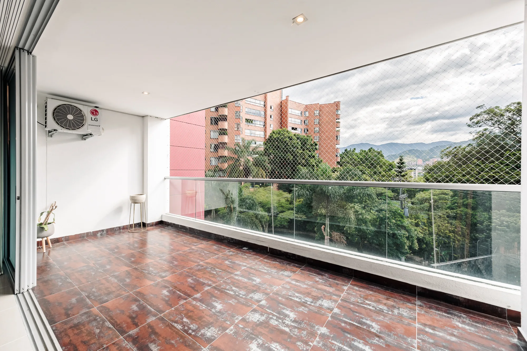 The full length of the tiled balcony with the glass doors folded right back at Balcón Verde