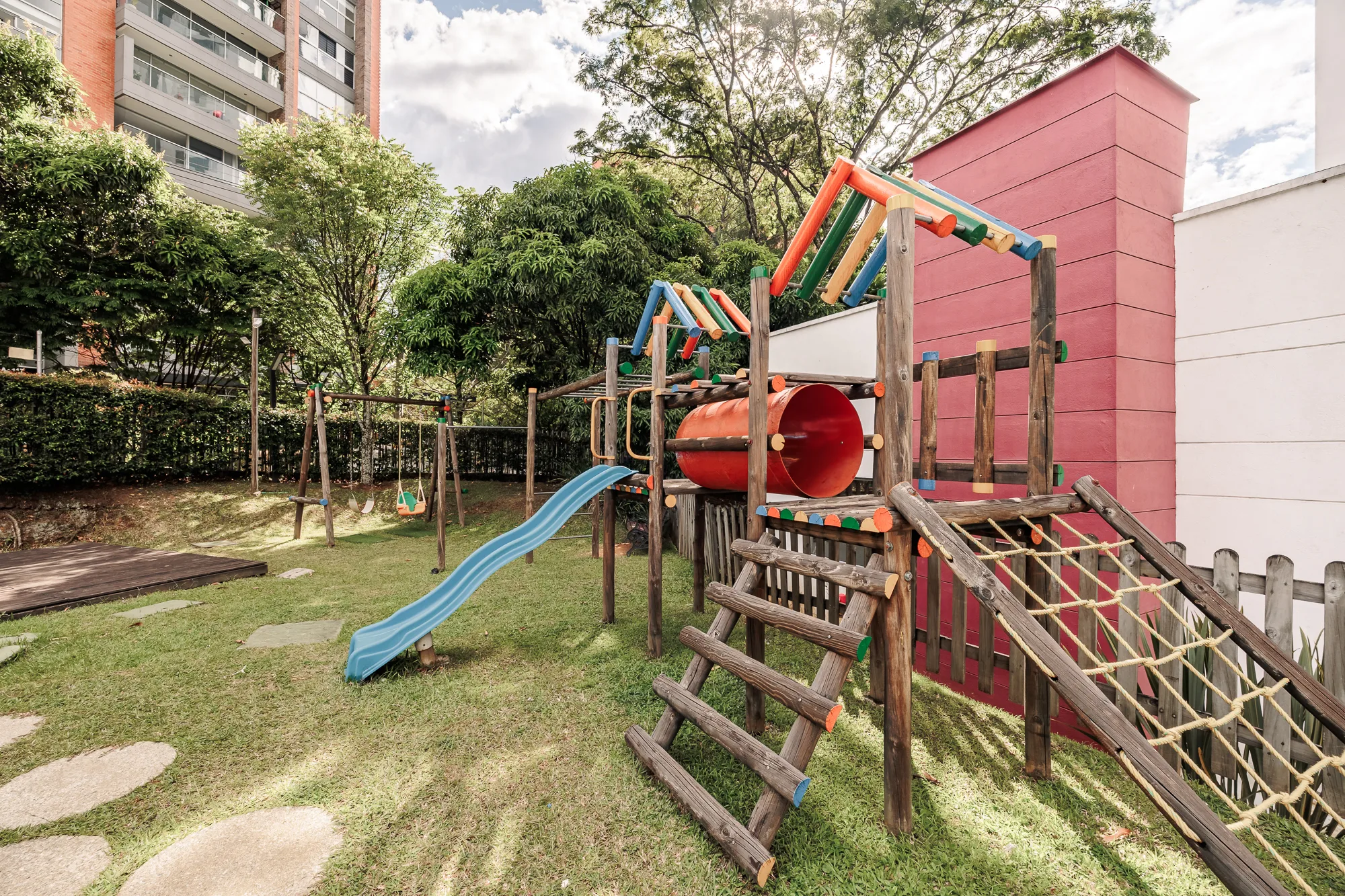 Children's playground in the building's private green areas at Balcón Verde