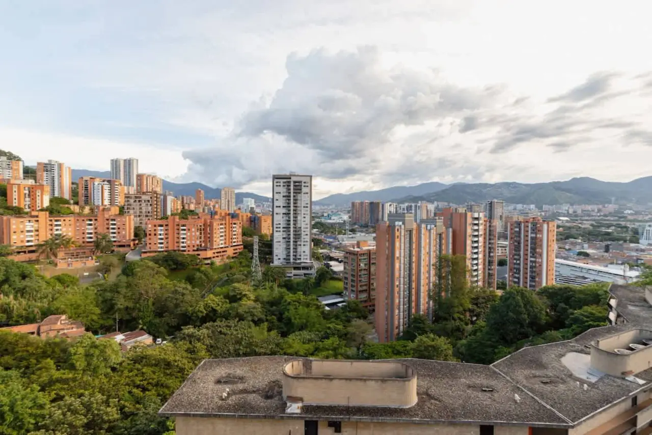 The city, the green slope and the mountains, seen from the balcony