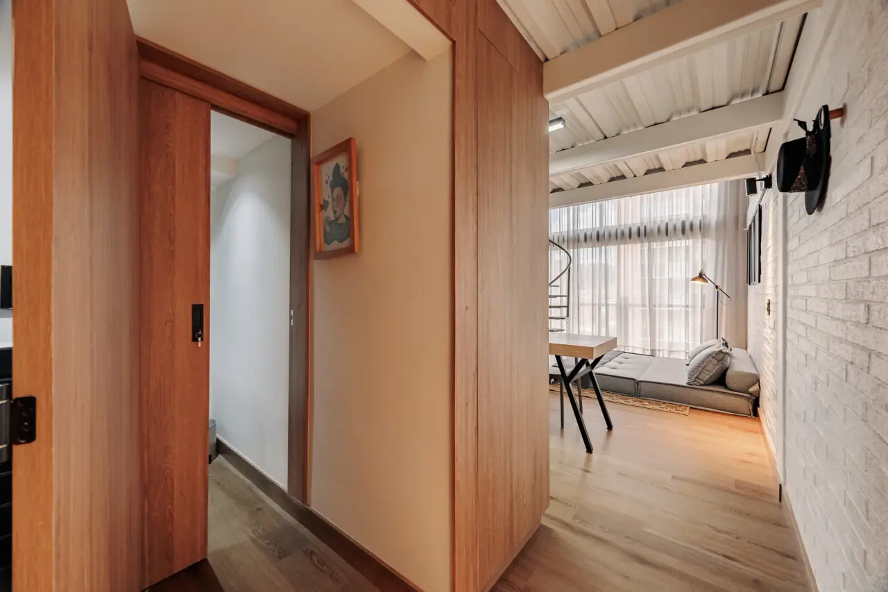 Timber door opening onto the living room at Downtown Loft