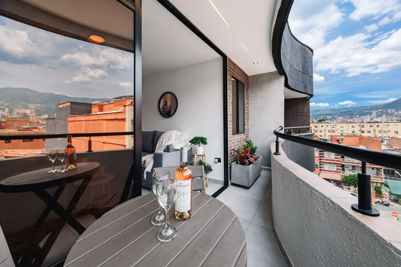 Balcony table with the living room behind it and the valley on both sides