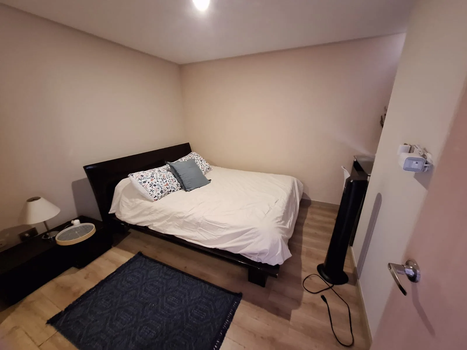 Primary bedroom with wood floors and a calm, neutral palette at Sabaneta Parkside