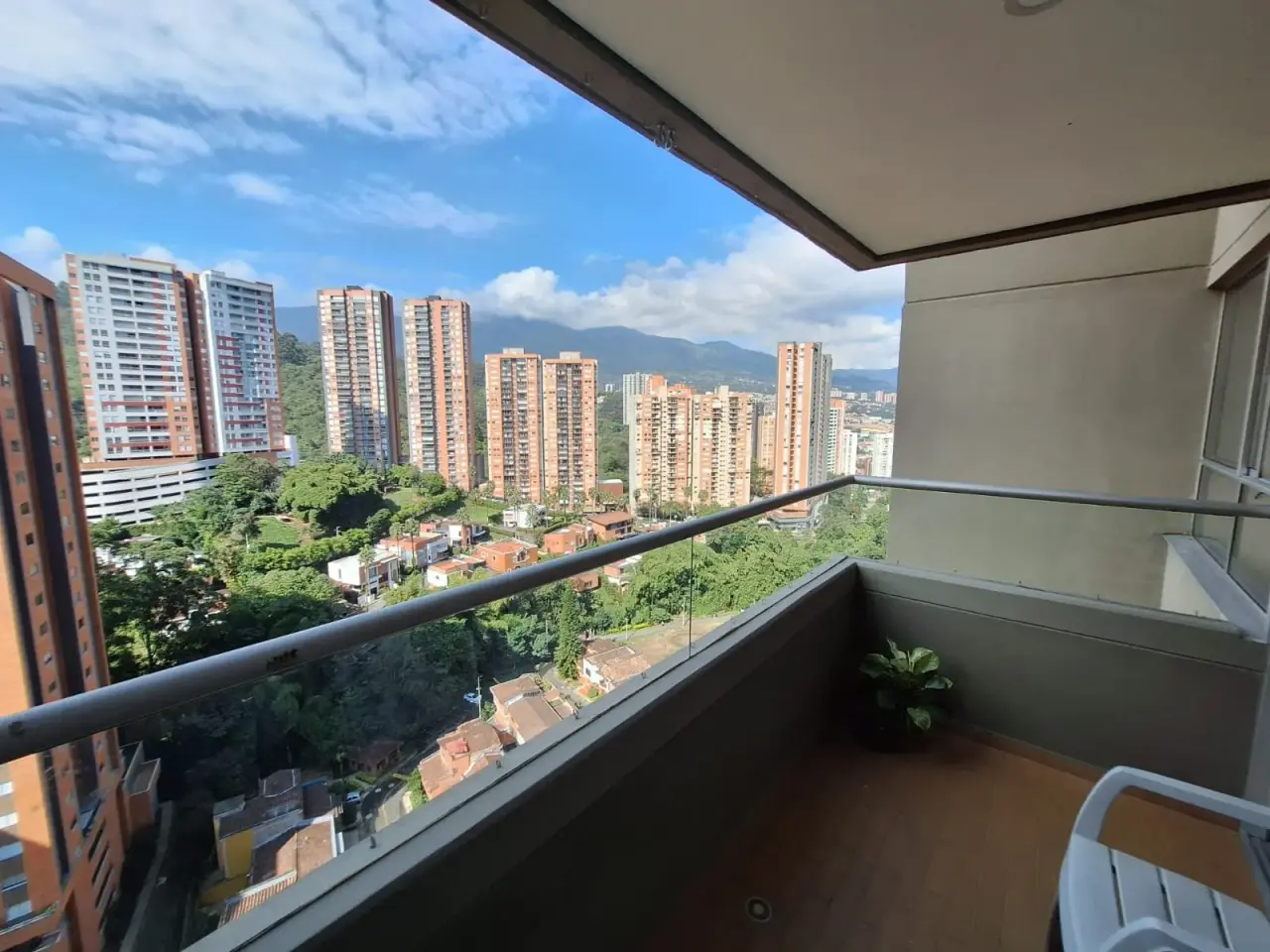 Balcony at Sabaneta Parkside with an open view over green hillside and Sabaneta's residential towers