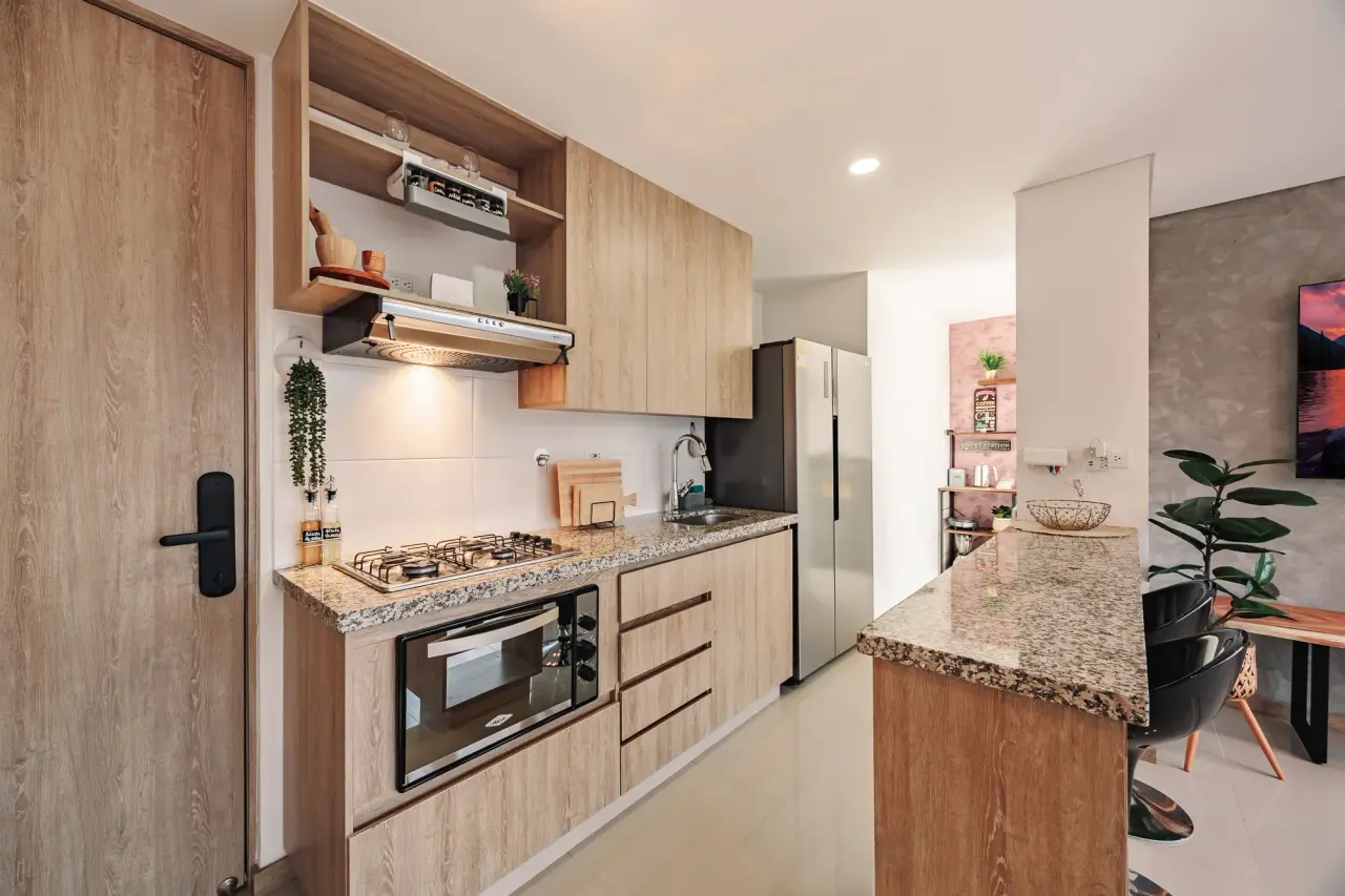 Kitchen worktop, stove and oven under warm wood cabinets