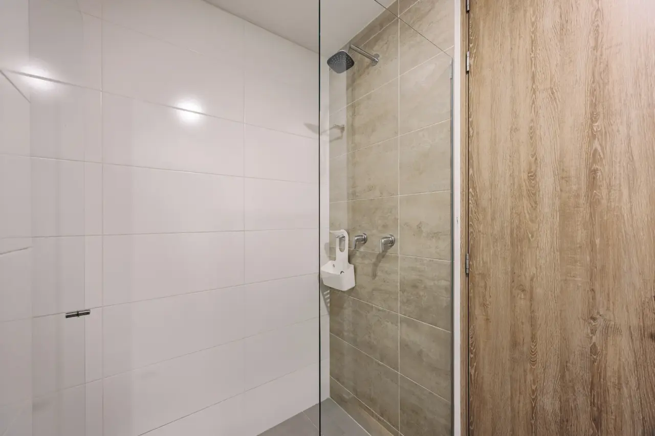 Social bathroom shower in white tile